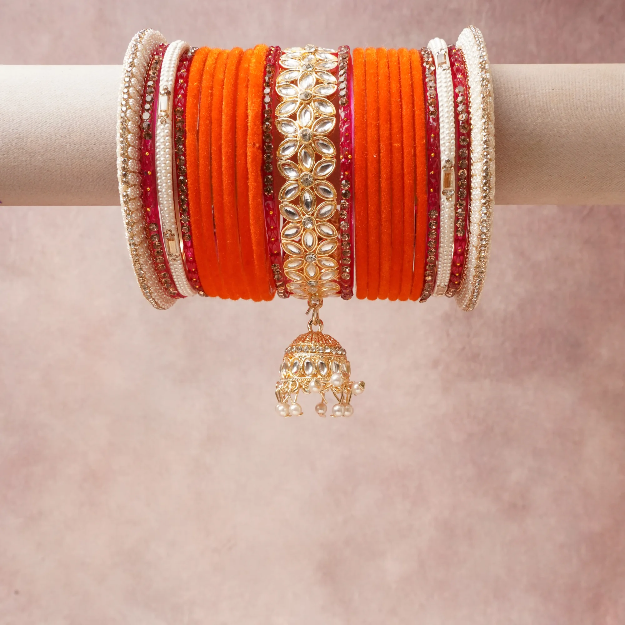 A commanding Saffron Orange anchors this beautiful set, enriched with accents of Antique Gold, Ruby Red, Fuchsia, Pearl White that add depth and dimension.

Featuring a striking composition of Velvet, Gold-plated Metal, Kundan, Glass, Cultured Pearls, Rhinestones, this set carries intricate craftsmanship and strong presence. Grand in form, it is created for moments that deserve to be marked.
